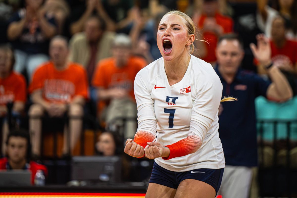 Junior Setter Kenna Phelan celebrates as a point is scored to put Illinois further ahead during its match vs. Oregon Sept. 26.