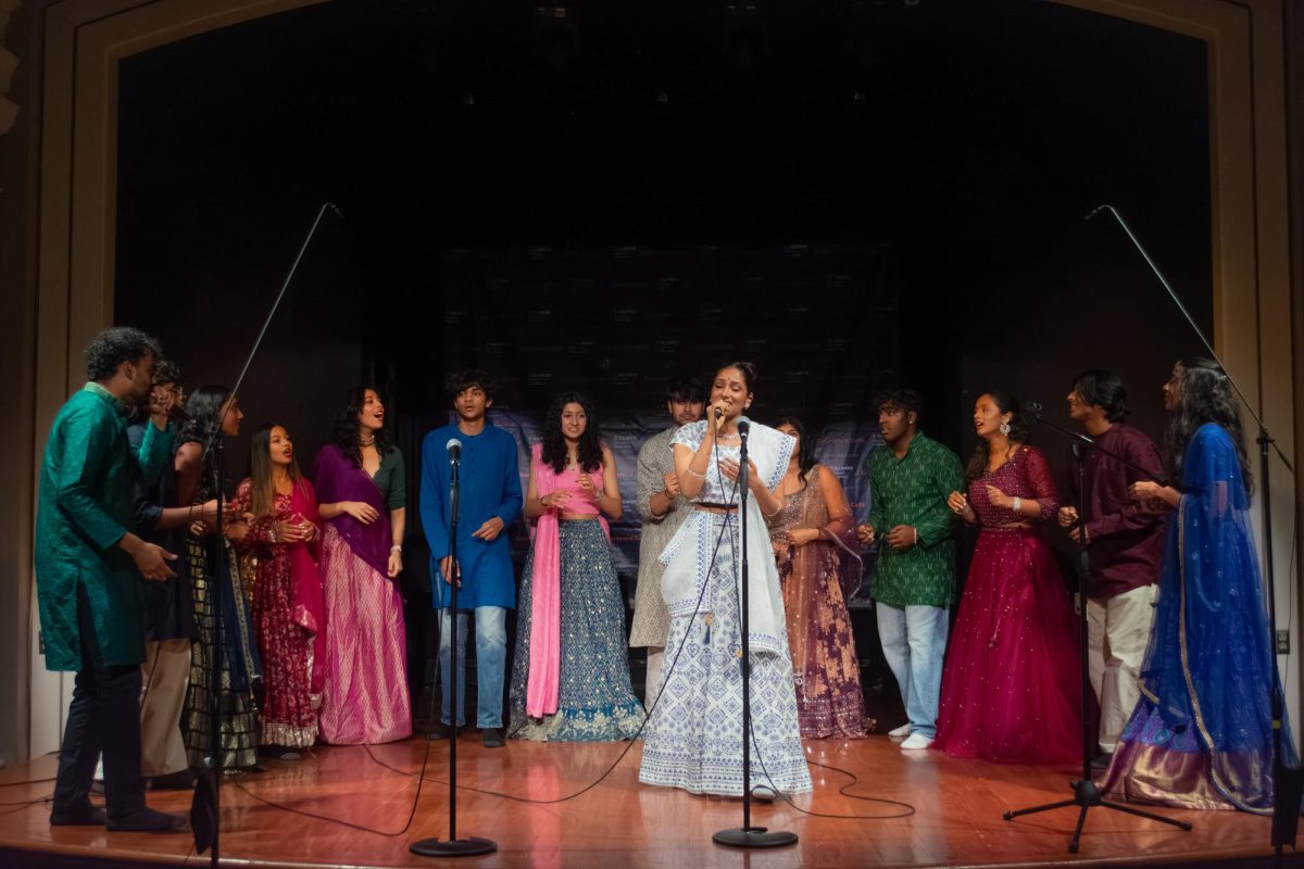 A soloist with the Illini Awaaz, a Bollywood-pop fusion a cappella group, performs in the Courtyard Cafe of the Union on Saturday. Their act was part of a lineup of singing and dancing performances for Bollywood Night, hosted by the Illinois Graduate Student Association.