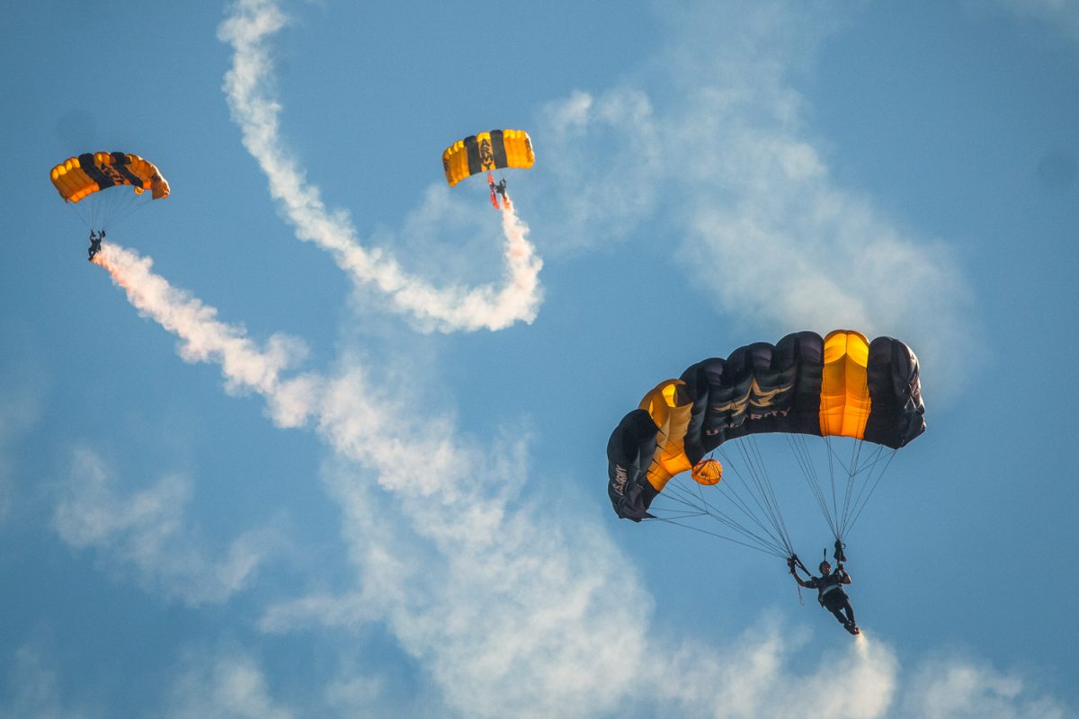 The U.S. Army Golden Knights Parachute Team descends onto Zuppke Field to kick off the Homecoming game. (Elena Baker)