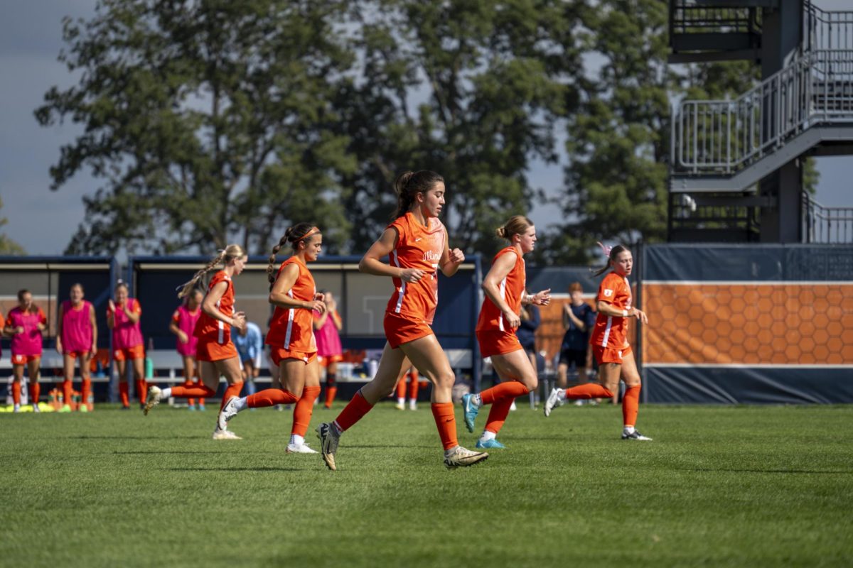 The Illini run to their positions ahead of the team's game against the Maryland Terrapins on Sept. 29, 2024.
