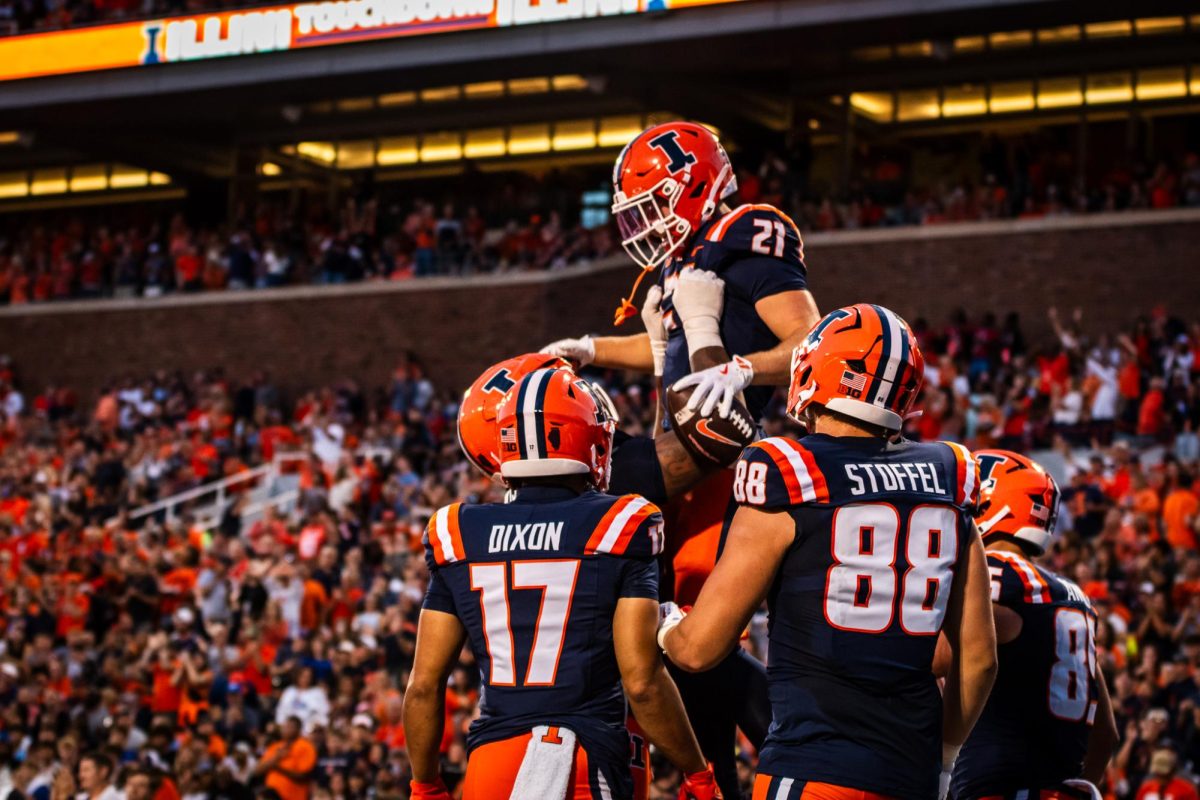 Junior running back Aidan Laughery is lifted up by his teammates during Illinois’ game against Western Illinois on Aug. 29. 