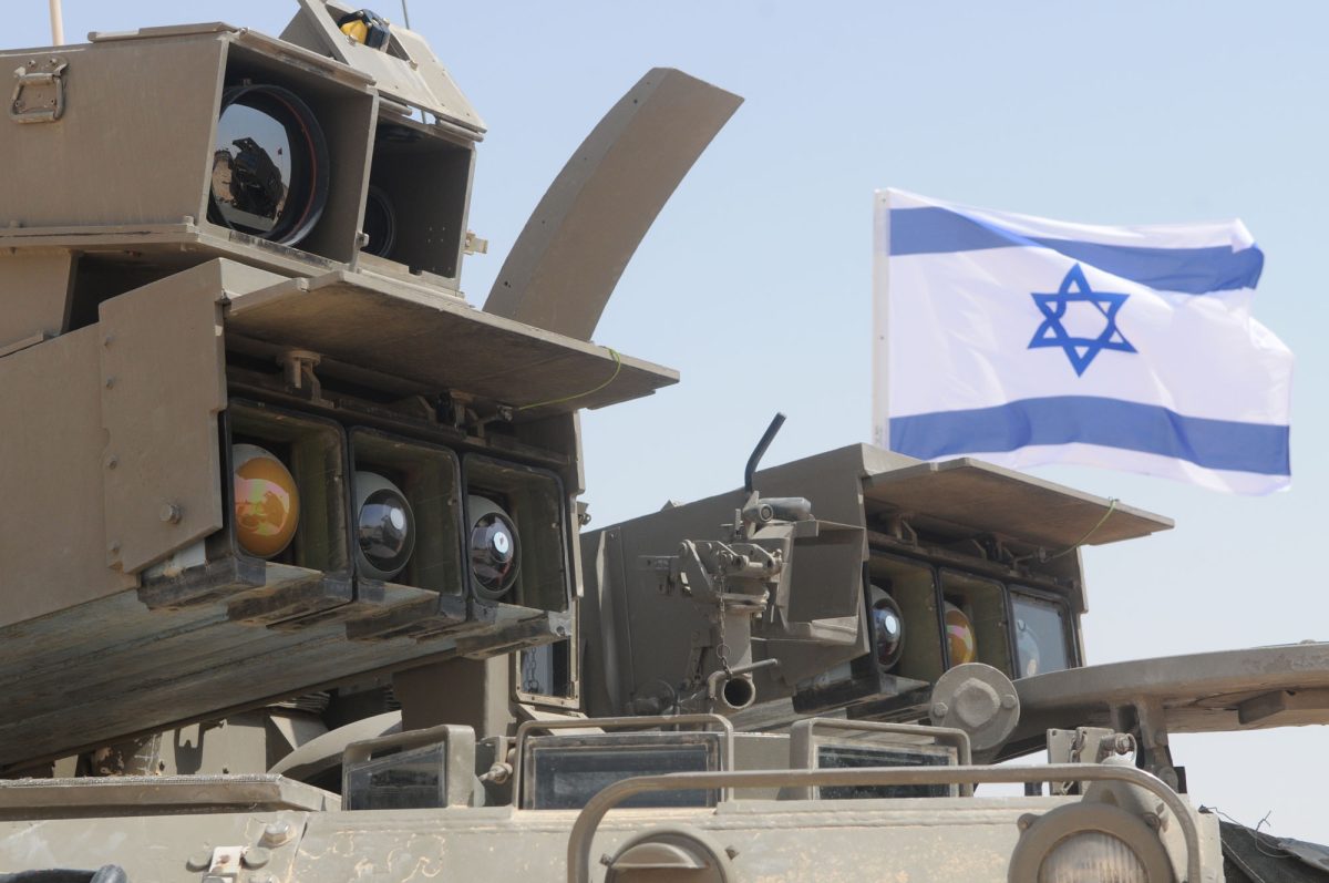 An Israel flag flies above an Israel Defense Forces artillery unit in 2011. A Guardian investigation found a University alum is part of an IDF sniper unit accused of killing several unarmed Palestinians. 
