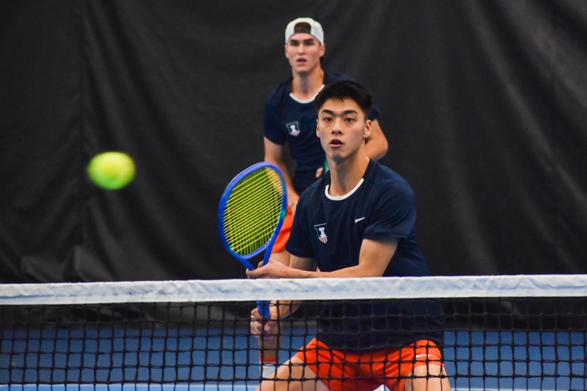 Mathis Debru, a senior, and Kenta Miyoshi, a junior, locked on the ball as their opponents hit the ball back toward them in a doubles match on Feb. 15.