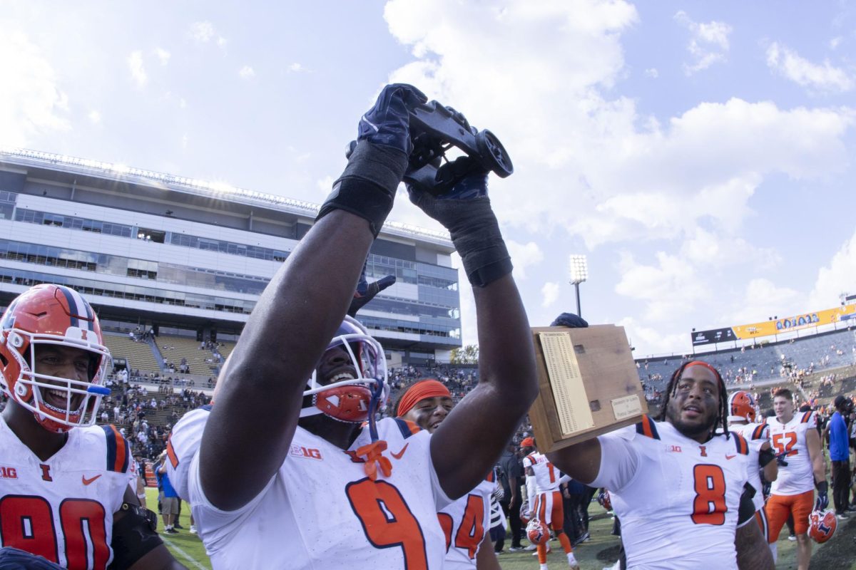 Linebacker Leon Lowery Jr. lifts the Cannon after Illinois beat Purdue 43-27 on Oct. 4.