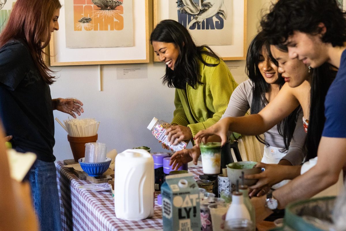 Staff members of Gatcha Matcha prepare matcha beverages at the University YMCA Fancy Friday evening sip and shop event on Sept. 26.