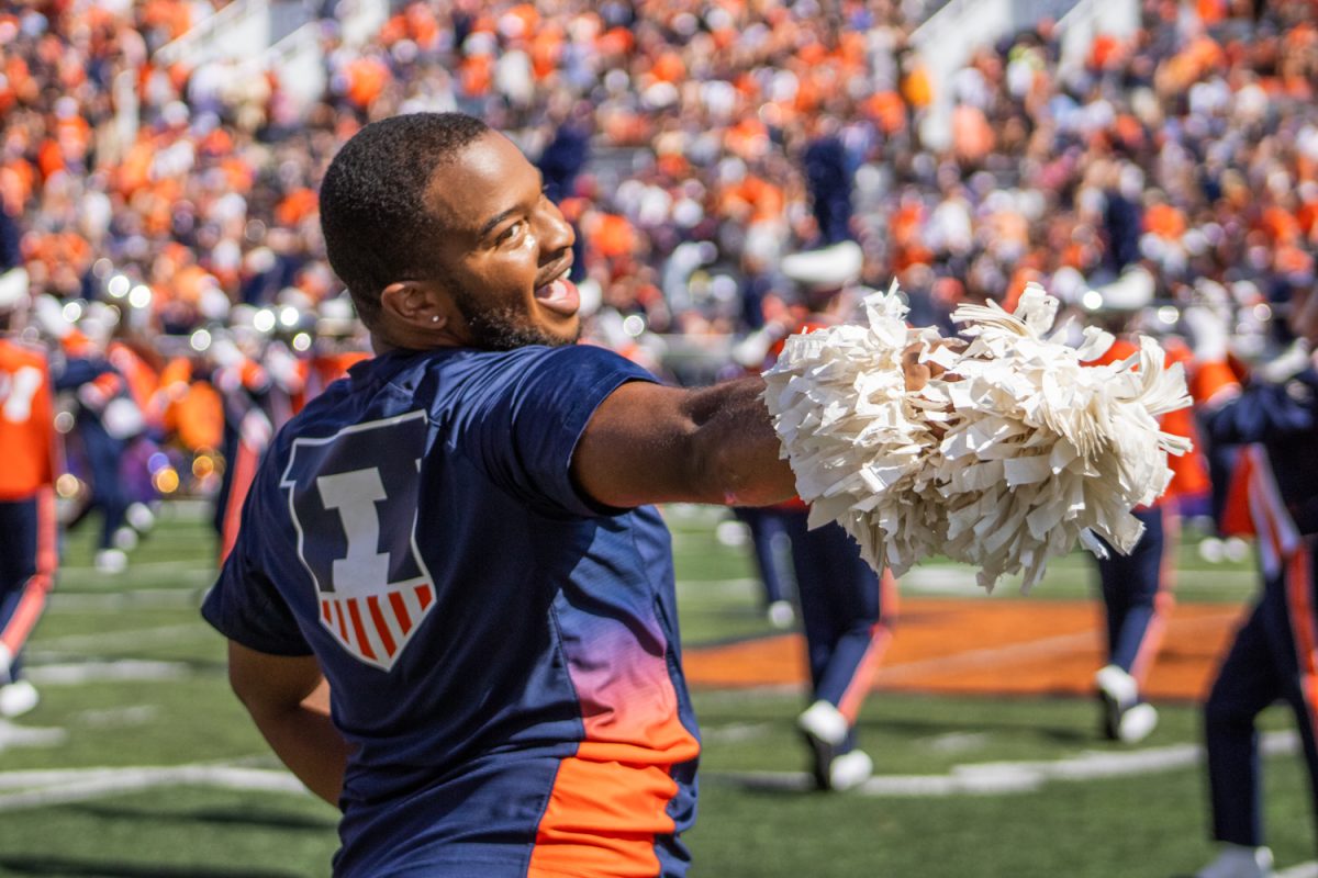 Jeremiah Jordan, junior in FAA, performs alongside the Illinettes dance team at a football game on Sept. 27. Jordan is a dance major, and he is the first male member of the Illinettes.