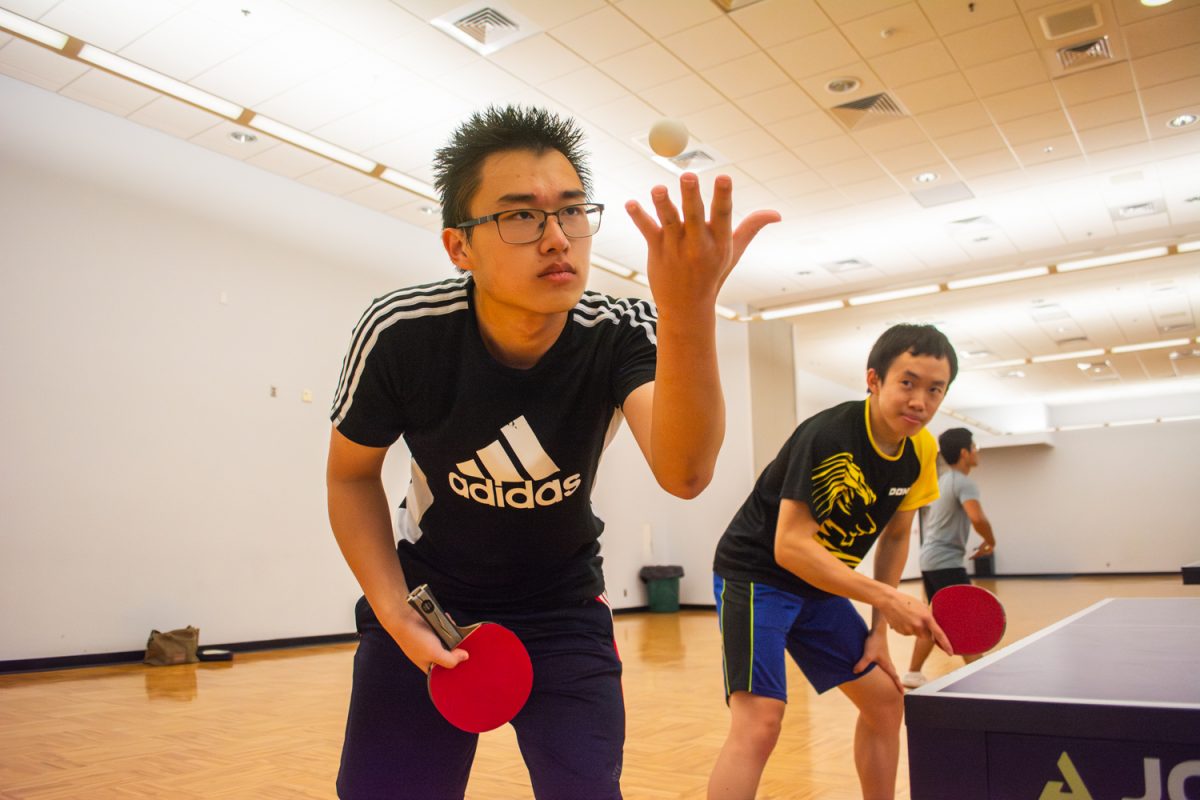 Stephen He, senior in Engineering, serves while his doubles partner, Wesley Wu, graduate student in Engineering watches, during a practice game on Oct. 1. They practice weekly as part of the UIUC Table Tennis Club, which competes nationally every year.