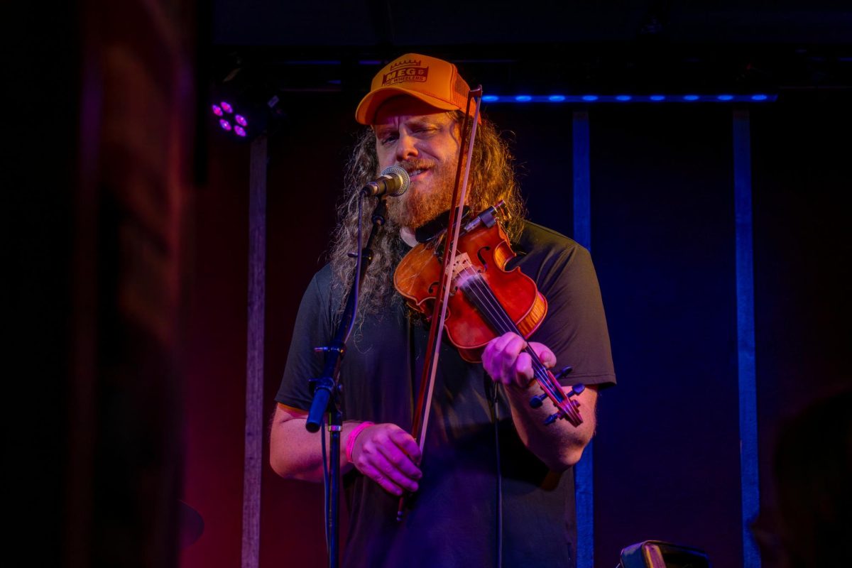 Brandon Reisdorf of The Illegal Smiles sings at the Rose Bowl Tavern for the CU Folk and Roots Festival on Oct. 4th. He is the fiddle, banjo, and vocals for this John Pine tribute band.
