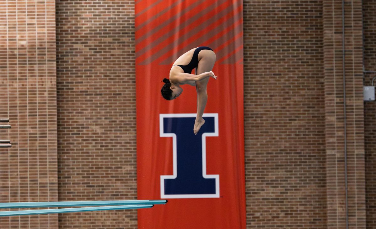 Sophomore Carlie Rose performs a reverse pike for her first dive. The Illinois Swim and Dive team hosted their own Orange vs. Blue meet at the Illinois ARC pool to open their season on Oct. 15.