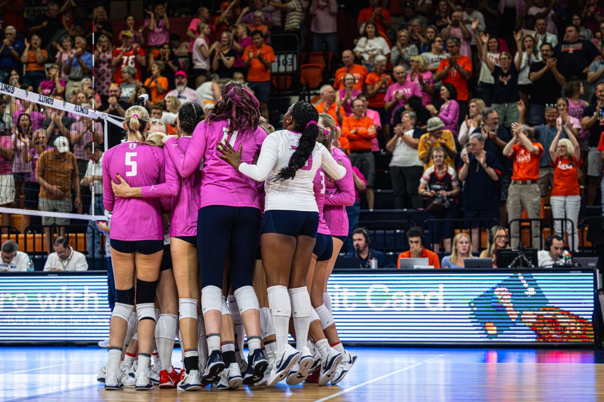 The entire Illinois volleyball team rushes the court to celebrate a win over Michigan State on Oct. 5. The final score of the match was 3 sets to 2.