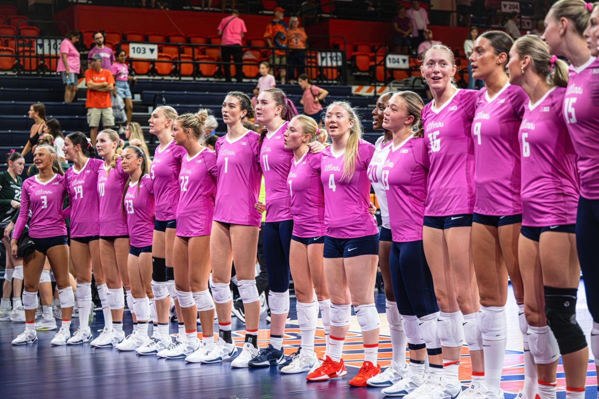 The Illinois volleyball team lines up in front of the student section to sing the Alma Mater following their win against Michigan on Oct. 5. Illinois won the match 3-2.