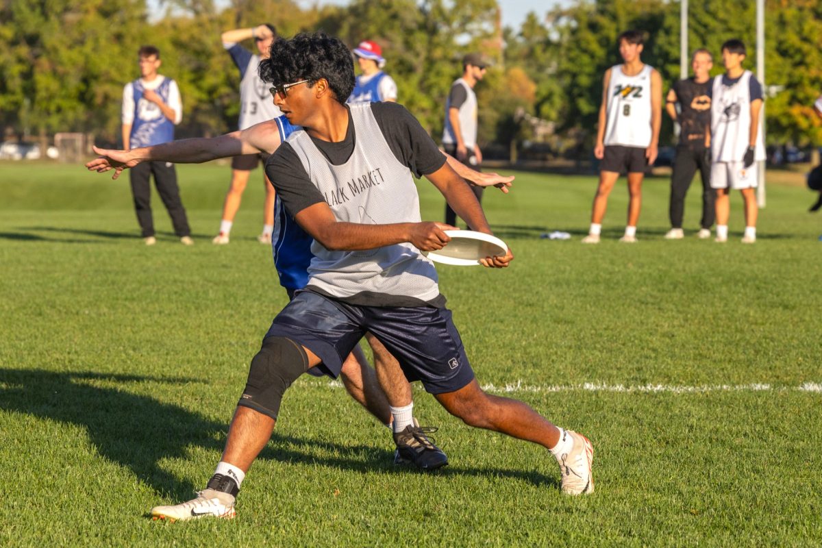 Junior Kushal Kuthapalli attempts to throw his frisbee away during an Oct. 8 practice for the Illinois Rise ultimate frisbee team at the FAR Complex Fields.