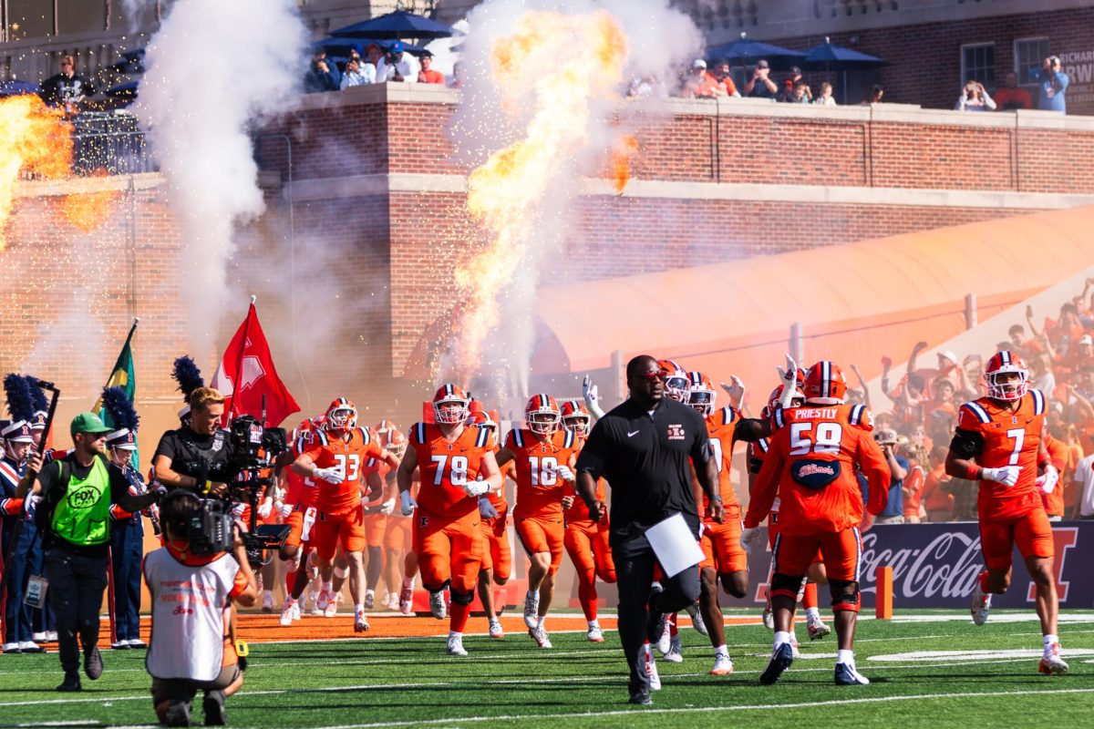 The Illini take the field at Gies Memorial Stadium ahead of the game against the Ohio State Buckeyes on Oct. 11.