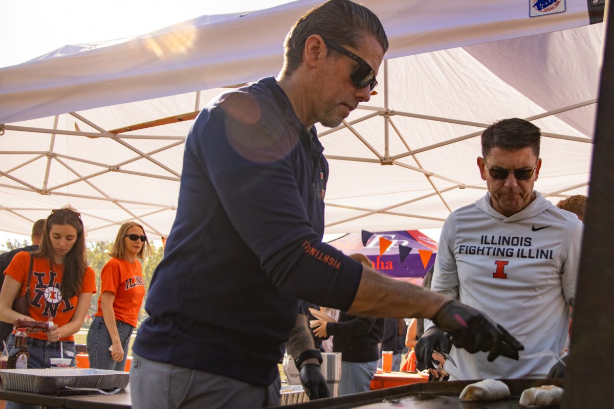 Ryan Anderson, a parent of an Illinois student, makes breakfast burritos for his family and friends before a football game on Oct. 11. He said this is only the second tailgate cookout he has hosted, but he wants to make it a tradition.