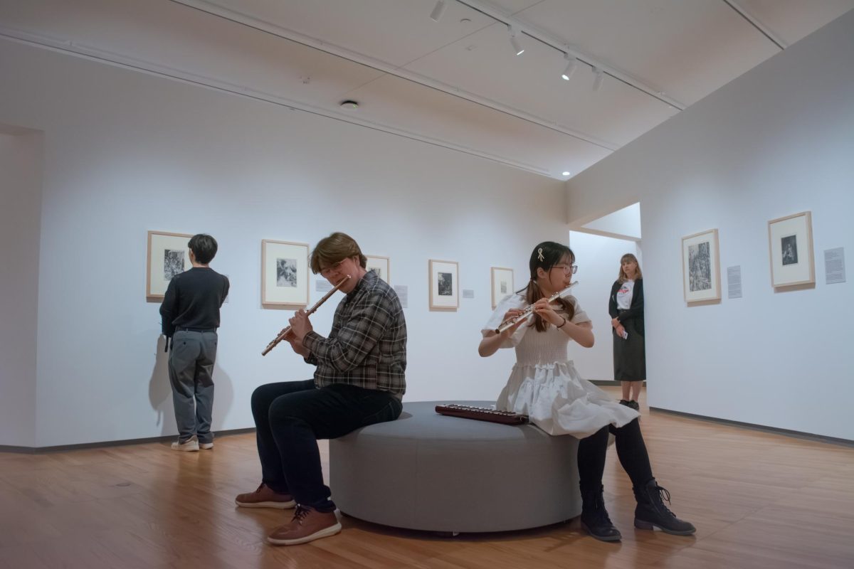 Liam Haynes, graduate student in FAA, and Elva Chang, junior in FAA, perform a flute duet in the East Gallery of the Krannert Art Museum as members of the Improvisers Exchange Ensemble in a performance on Saturday. The ensemble, founded in 2017 by Jason Finkelman, professor in FAA, follows a style Finkelman deems "omni-idiomatic", where musicians of diverse backgrounds and skill levels improvise together to create unique live performances.