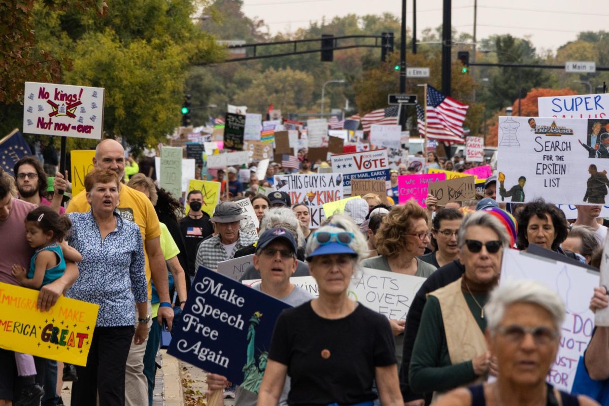 Following the initial speeches in front of the courthouse, protesters march through Downtown Urbana and down North Vine Street.