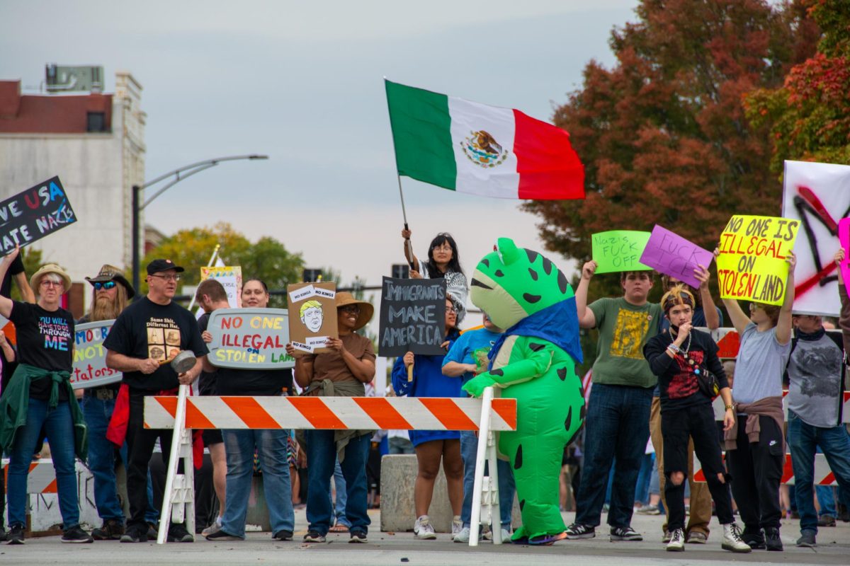 During the No Kings protest on Saturday afternoon, attendees supporting immigrants brought flags and cheered as cars honked their horns. The protest drew thousands to protest in Downtown Urbana.