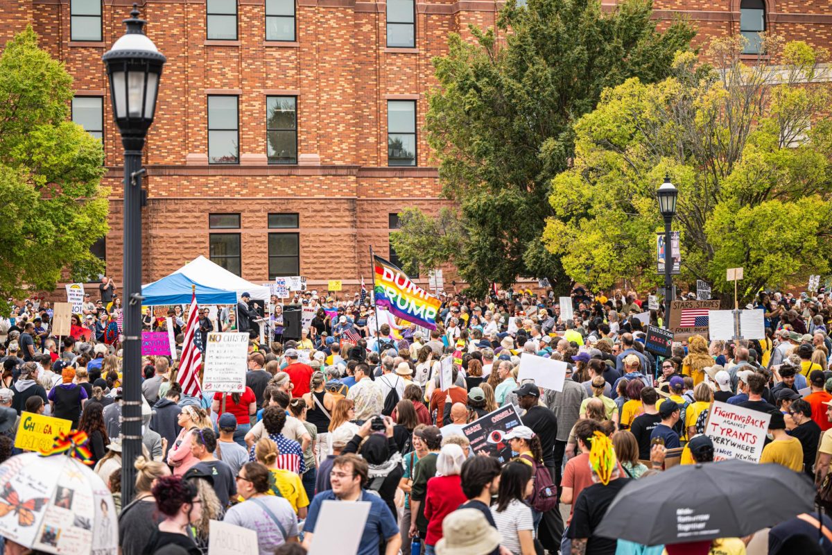 Thousands of people gather around a podium in front of the Champaign County Courthouse in downtown Urbana for the No Kings protest on Saturday. The protest featured several speakers before community members and students took to the streets to march.