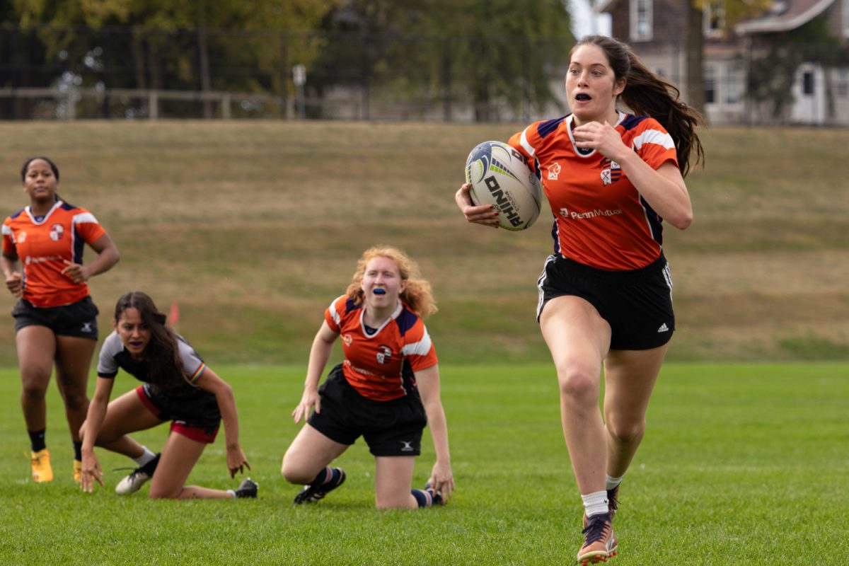 Sophomore full back Lilly Grant runs to make a try after receiving the ball. Illinois beat the University of Chicago 46-15 on Oct. 18 at the Florida and Lincoln Playing Fields in Urbana
