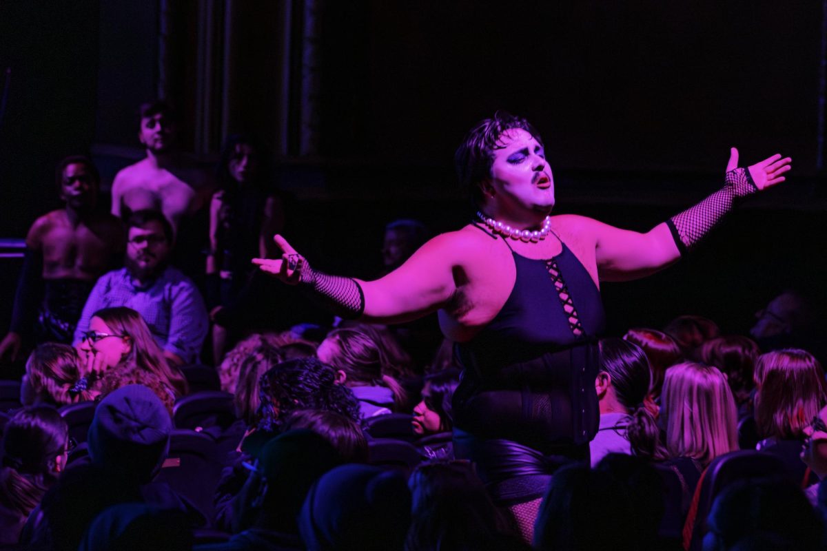 Dylan Holt performs as Doctor Frank-N-Furter in the Rocky Horror Picture Show at the Virginia Theatre on Saturday, Oct. 25. Holt and the rest of the shadow cast performed alongside the film projected on the screen, dancing through the aisles of enthusiastic audience members. 