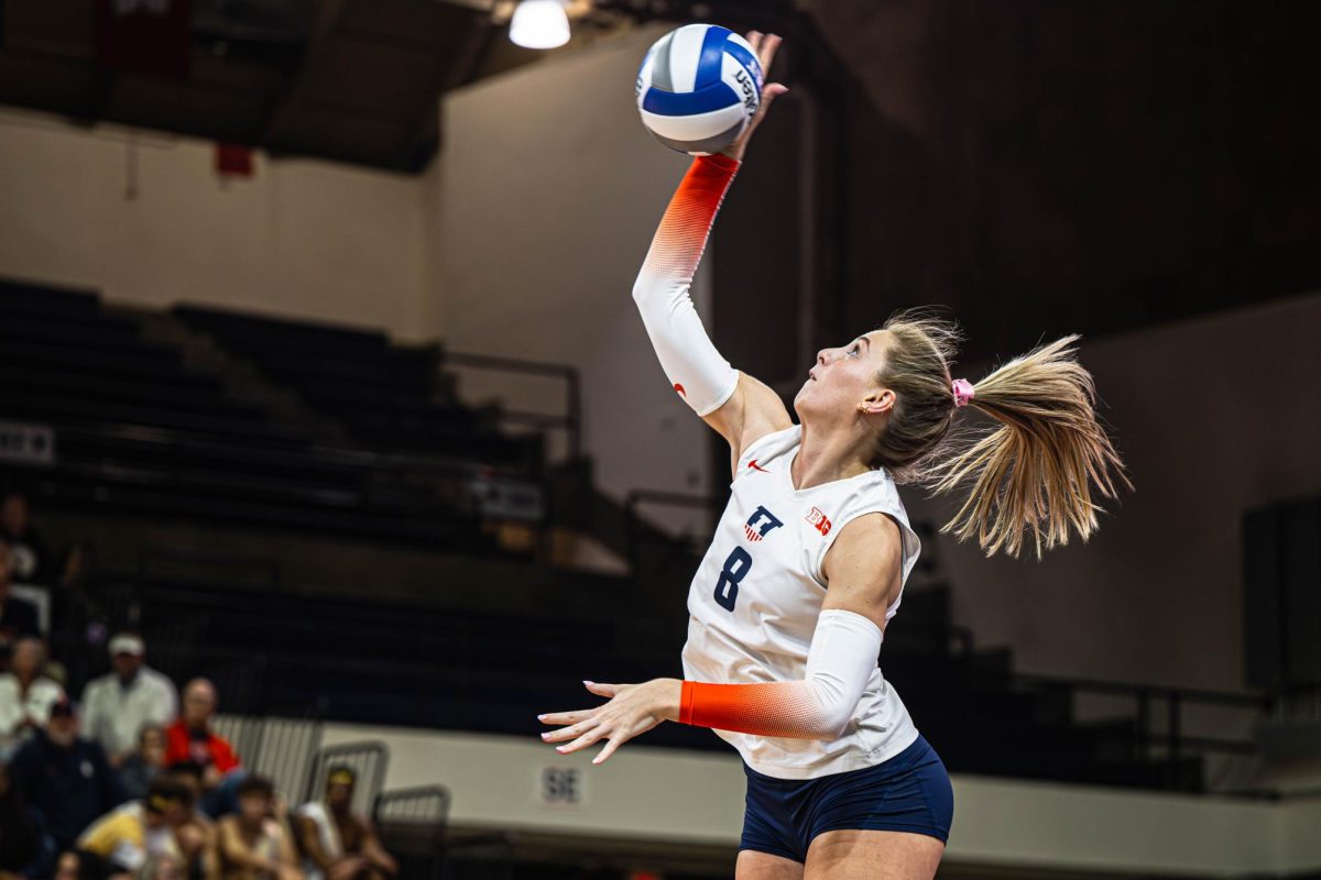 Senior outside hitter Averie Hernandez leaps to hit the ball against Michigan on Oct. 25. 
