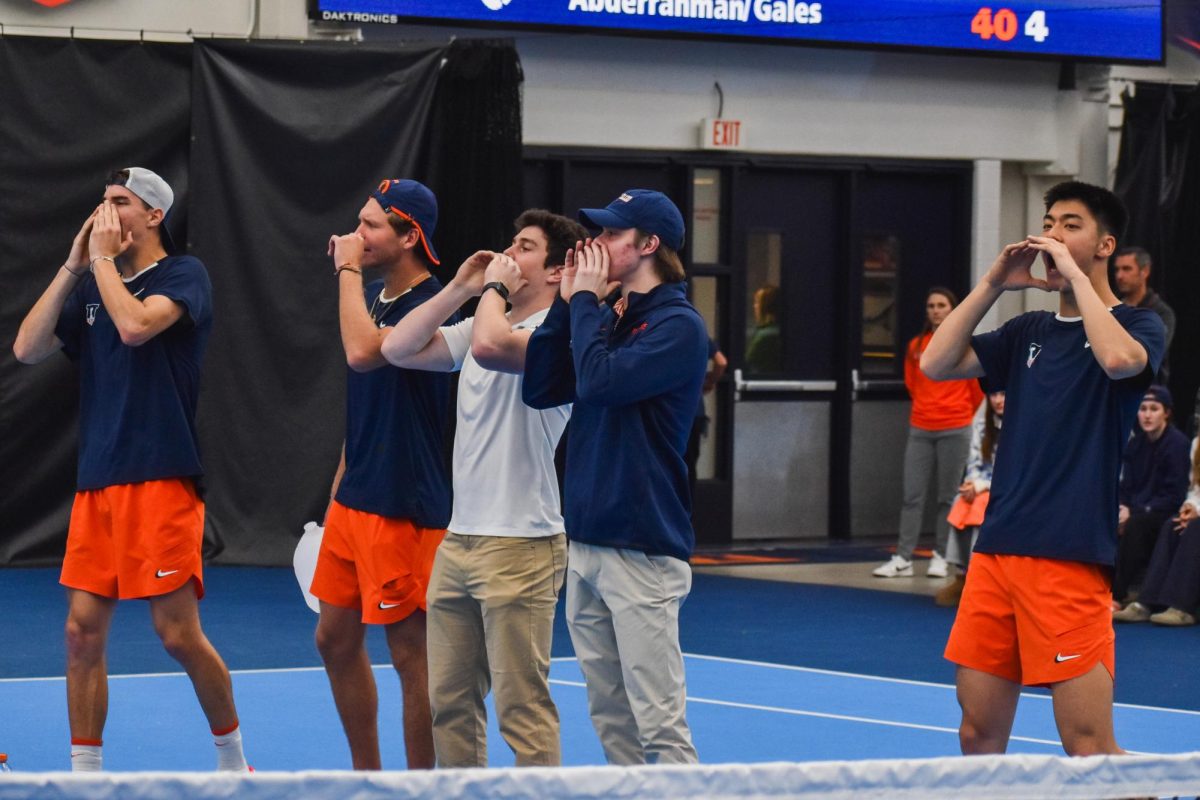 The Illini men’s tennis team cheer for their teammates from the sidelines during the Illiniois vs. Clemson meet on Feb. 15. Illinois won the match 4 to 3.