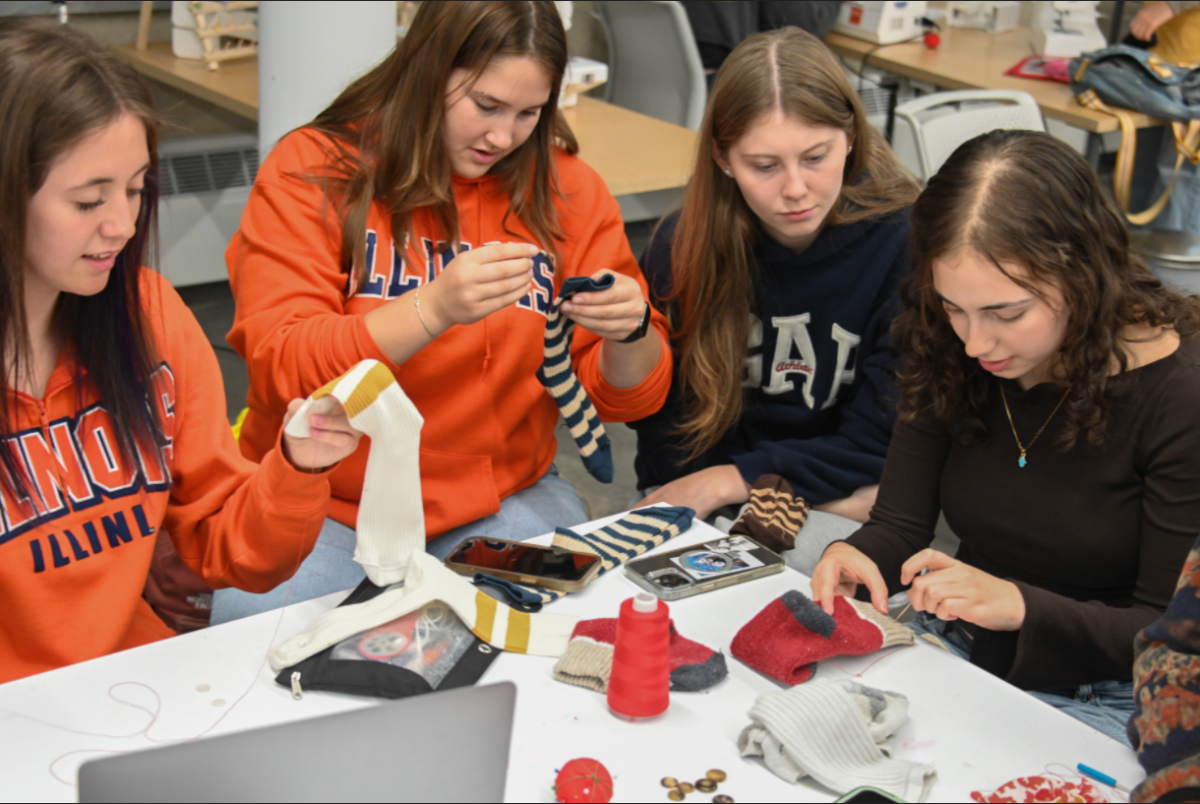 Students make sock monkeys out of old socks as part of a collaborative workshop between the Circular Fashion Expo and Students for Environmental Concerns on Thursday.
