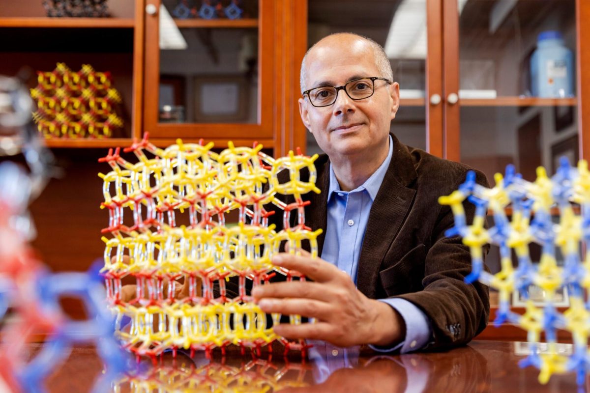 Illinois alum Omar Yaghi, one of three recipients of the 2025 Nobel Prize in Chemistry, sits at a desk with molecular models. Yaghi earned a doctorate in chemistry from the University in 1990. 