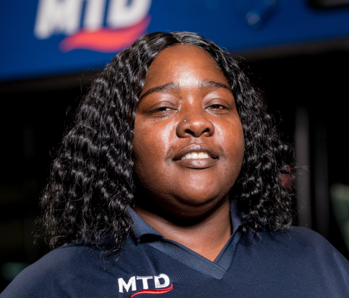 Bus operator Nafisah Freeman stands in front of MTD bus on Oct. 21.