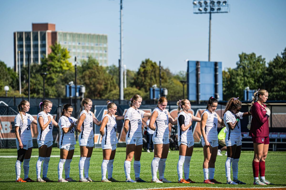 The Illini starters line up for the national anthem ahead of the team’s match against the Boilermakers on Oct. 12. 