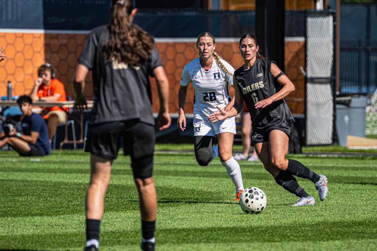 Illinois sixth-year midfielder Sydney Stephens fights for the ball during the team’s match against Purdue on Oct. 12.  