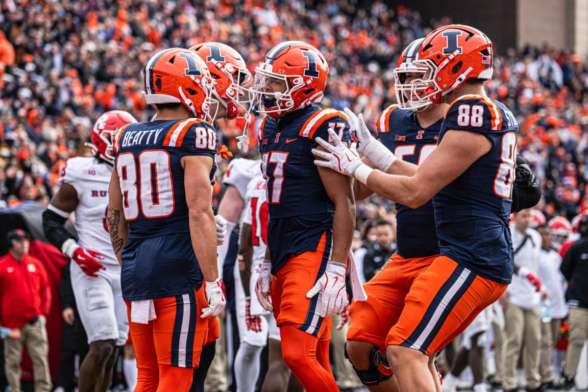 (L-R) Senior wide receiver Hank Beatty, sophomore wide receiver Collin Dixon and sophomore tight end Davin Stoffel celebrate with teammates during Illinois’ win over Rutgers on Nov. 1. 