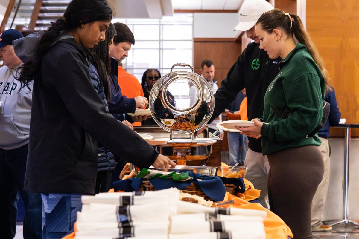 Illinois students and their families take food at the brunch hosted by the Illini Dads Association at the Alice Campbell Alumni Center on Nov. 2 during Illinois' Dads Weekend. 