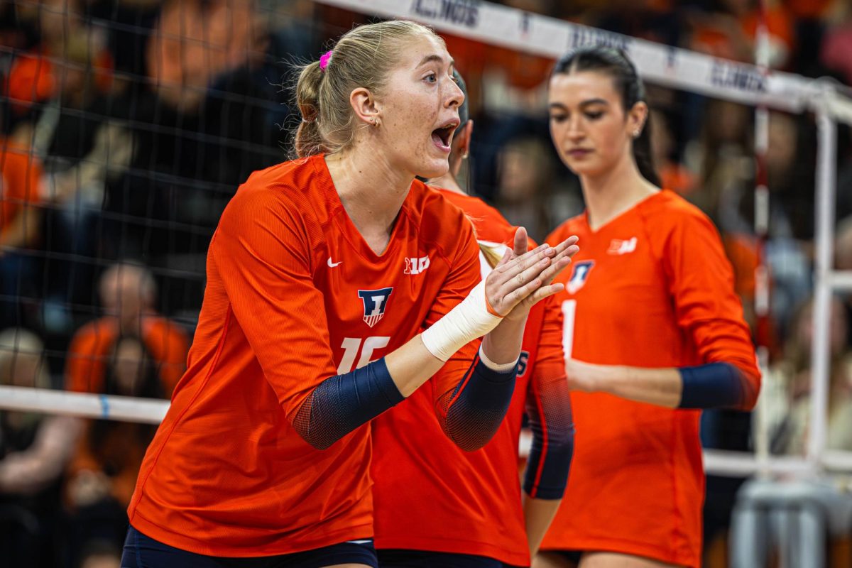 Sophomore outside hitter Ashlyn Philpot claps during Illinois’ match against Iowa on Nov. 2. 