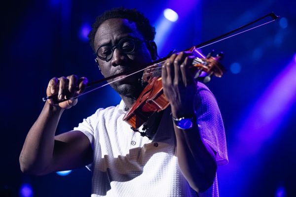 Wil B of Black Violin looks out to the crowd as they begin their high energy performance at the Virginia Theatre on Wednesday. The group made a stop in Champaign-Urbana as they continued on their Full Circle Tour.