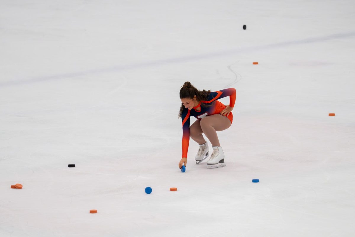 Illini Ice Girl Sara Wodnicki chooses the winning puck after the “Chuck-a-Puck” game during the second intermission of a hockey game at the University of Illinois Ice Arena on Nov. 14.