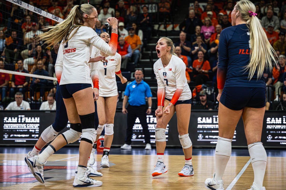 Junior setter Kenna Phelan (No. 7) and the Illini celebrate during the team’s match against the Wisconsin Badgers on Nov. 15. 