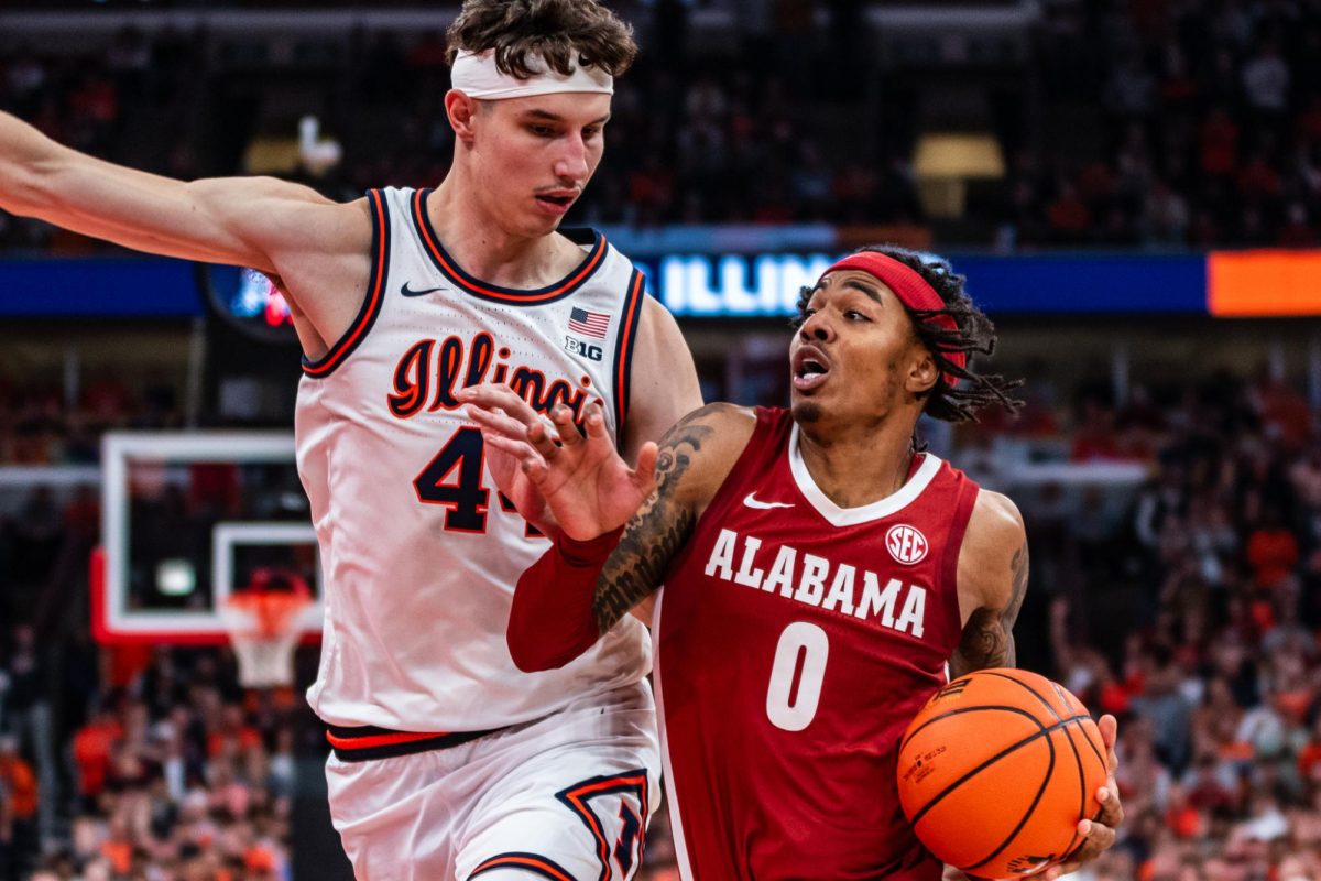 Alabama sophomore guard Labaron Philon Jr. drives to the basket against Illinois junior center Zvonimir Ivišić at the United Center on Nov. 19.
