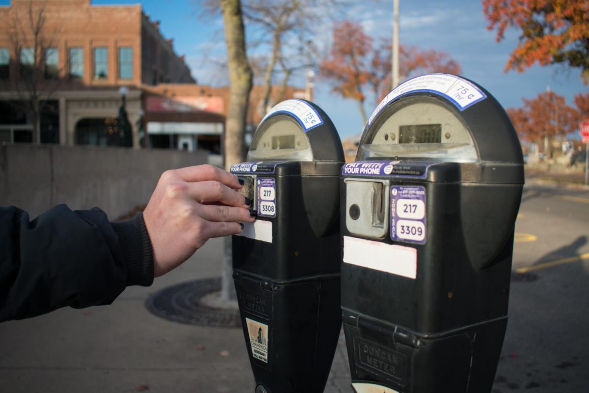 A person paying at a parking meter on North Chestnut Street in Champaign on Nov. 18. The City of Champaign is considering increasing the price of meters.