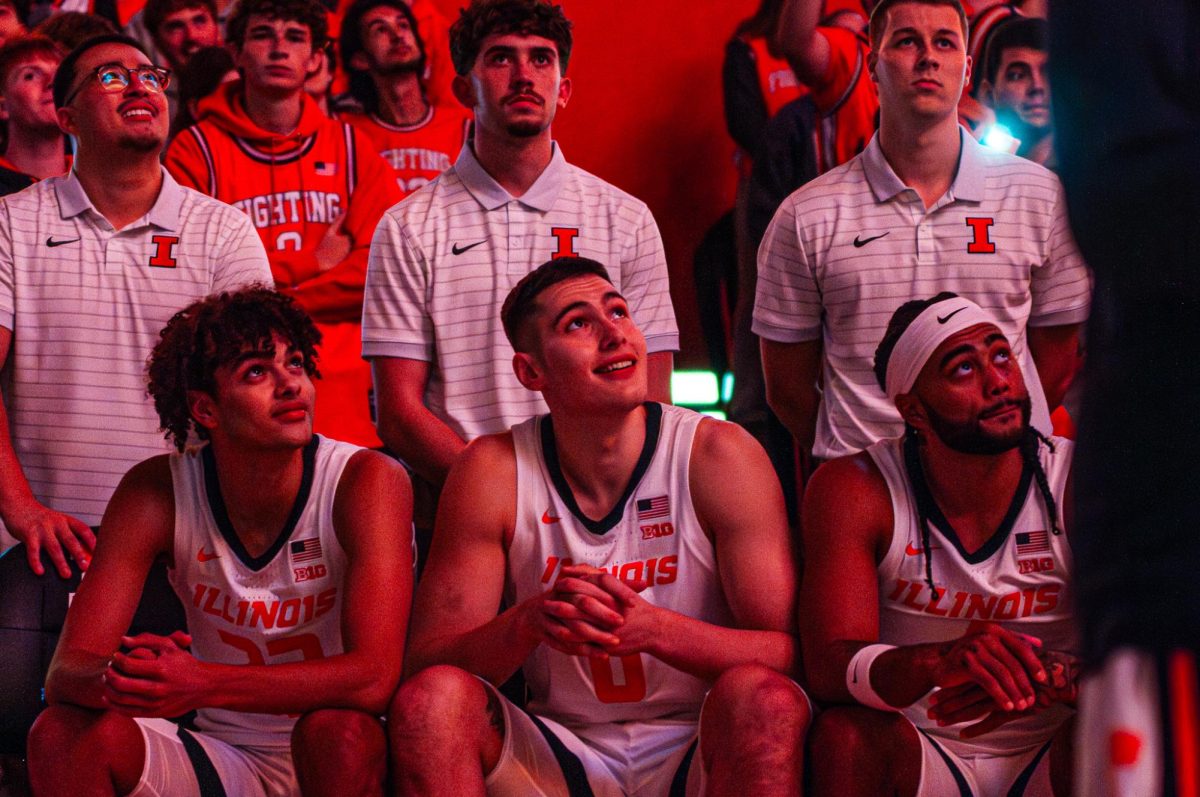 Illinois freshman guard Keaton Wagler (left), freshman forward David Mirković (center) and senior guard Kylan Boswell (right) sit on the bench during starting lineup introductions against Jackson State on Nov. 3.