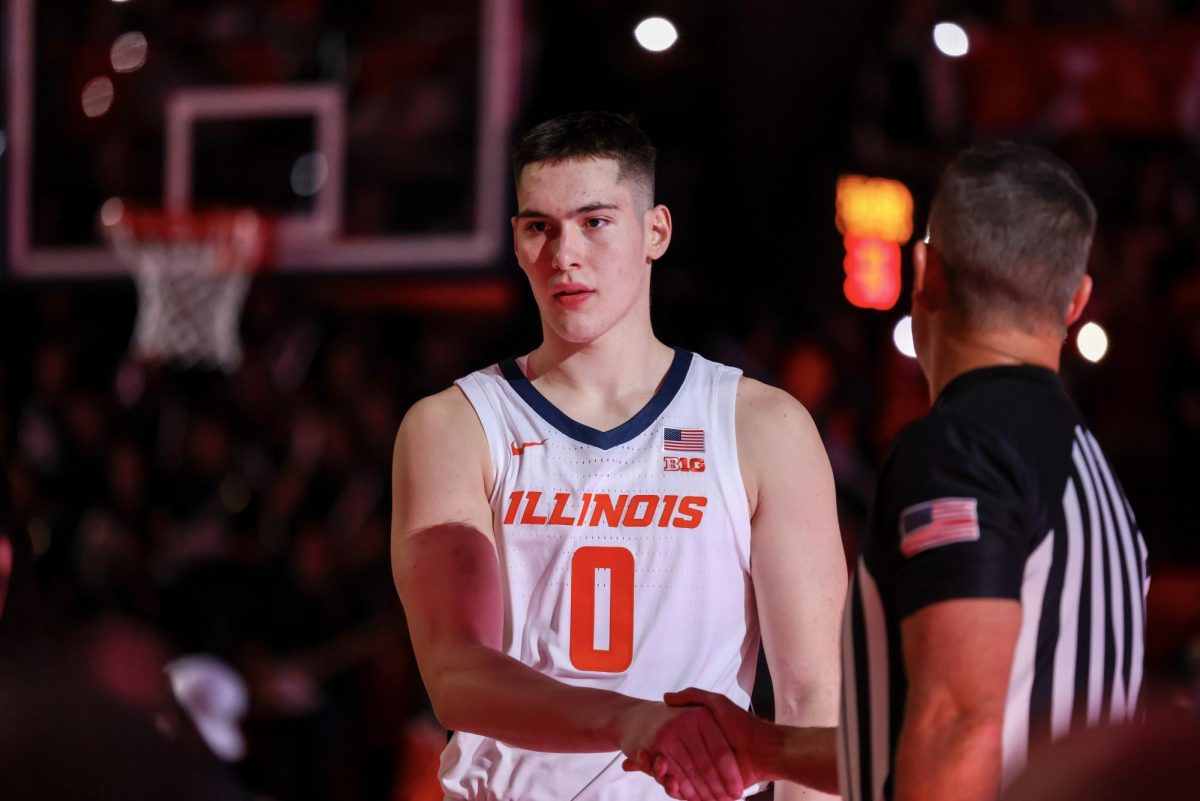 Illinois freshman forward David Mirković shakes a referee’s hands during pregame introductions before his Illini debut on Nov. 3.