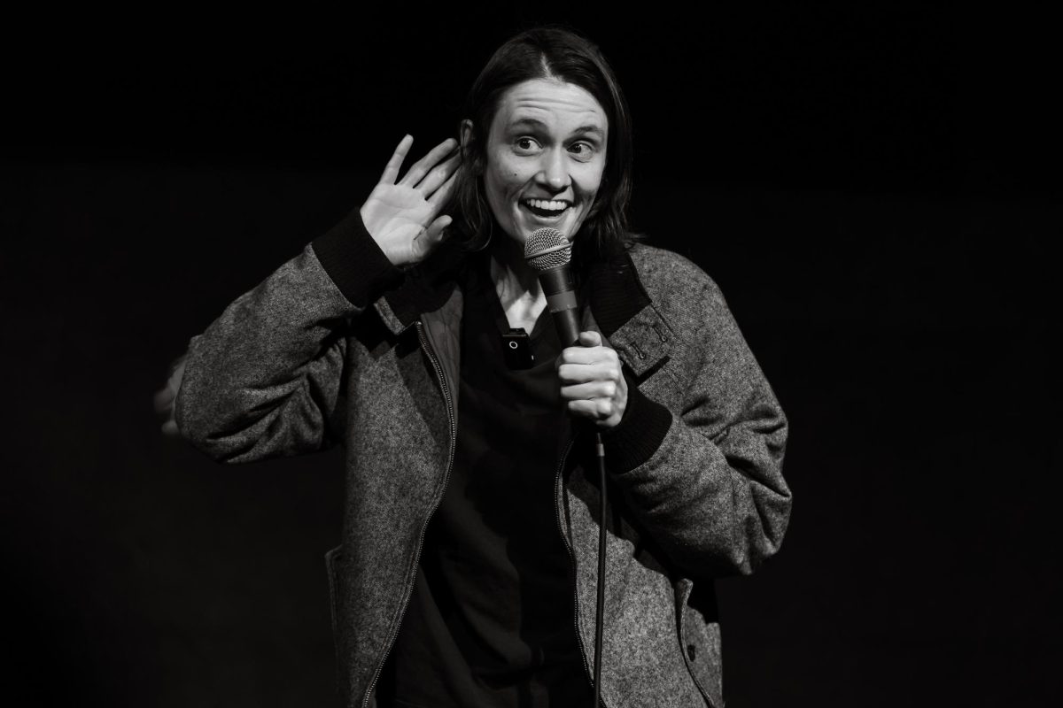 Comedian Heather Shaw interacts with the crowd during a comedy show.