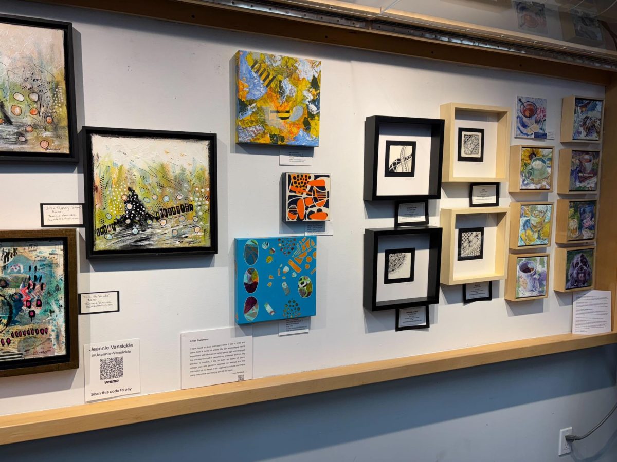 Paintings by the Artists of Marm hang on the wall at Common Ground Food Co-op in Urbana on Wednesday.