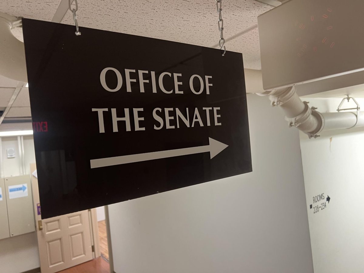A sign for the Office of the Senate hangs from the ceiling on the second floor of the English Building on Oct. 21. The University Senate will vote on a proposal to lower the foreign language requirements for online degree completion programs.