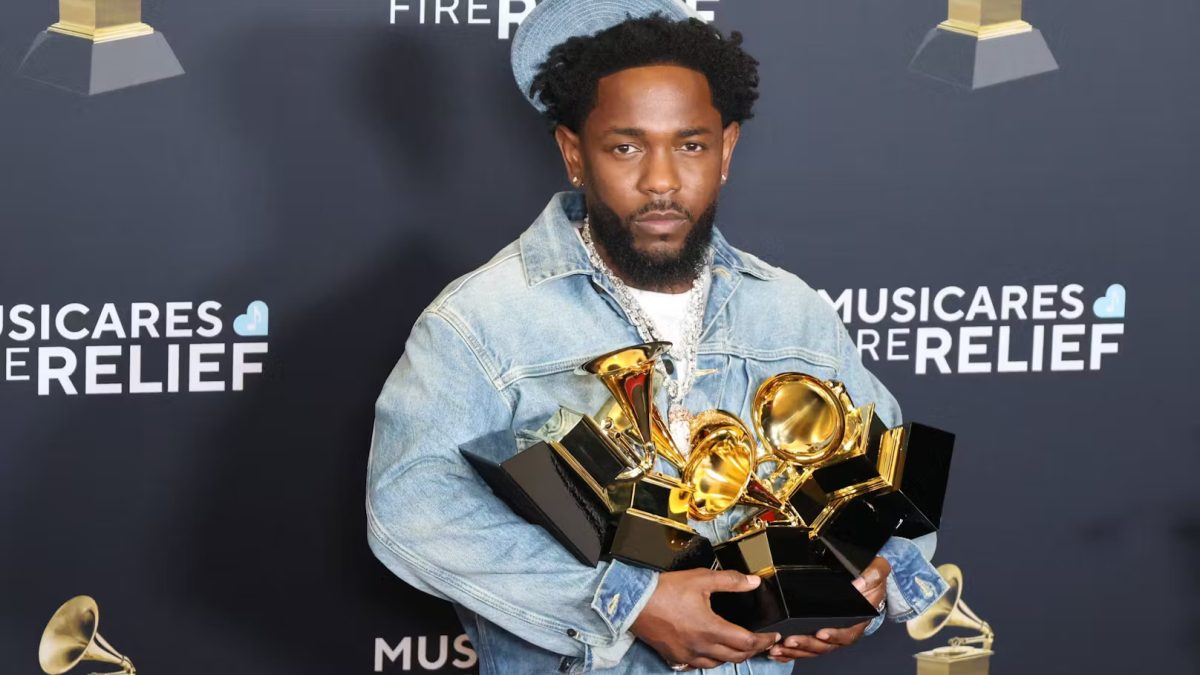 Kendrick Lamar holds the five Grammy Awards he won in 2025.