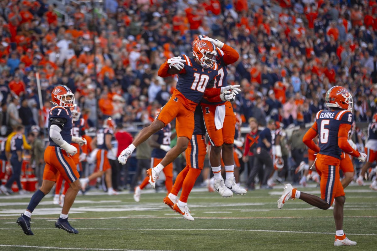 Senior defensive back Miles Scott celebrates a takeaway with senior linebacker Gabe Jacas during Illinois’ win over Maryland on Nov. 15.