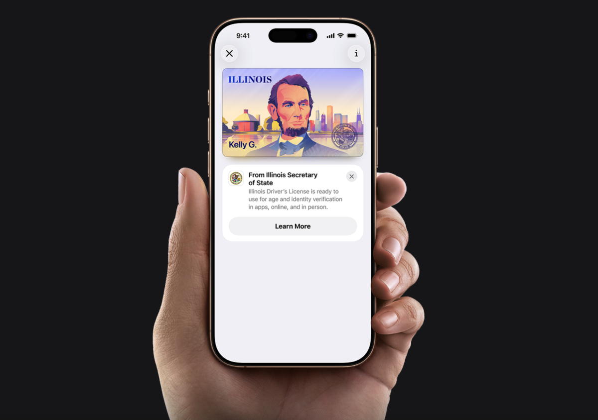 A hand holds an iPhone showing a digital Illinois ID on Apple Wallet. Illinois Secretary of State Alexi Giannoulias announced Illinoisans will be able to carry their licenses and IDs digitally.
