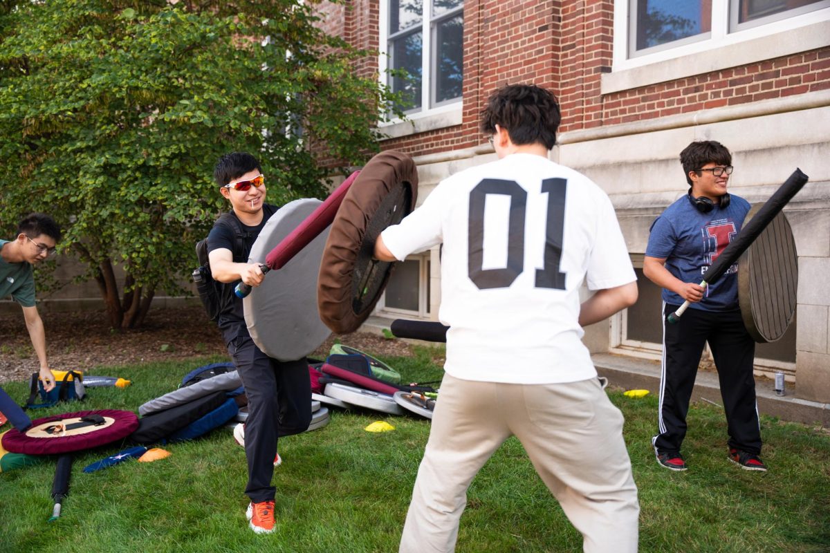 Students battle with padded swords and shields as part of the University Belegarth chapter during Quad Day, Aug. 24.