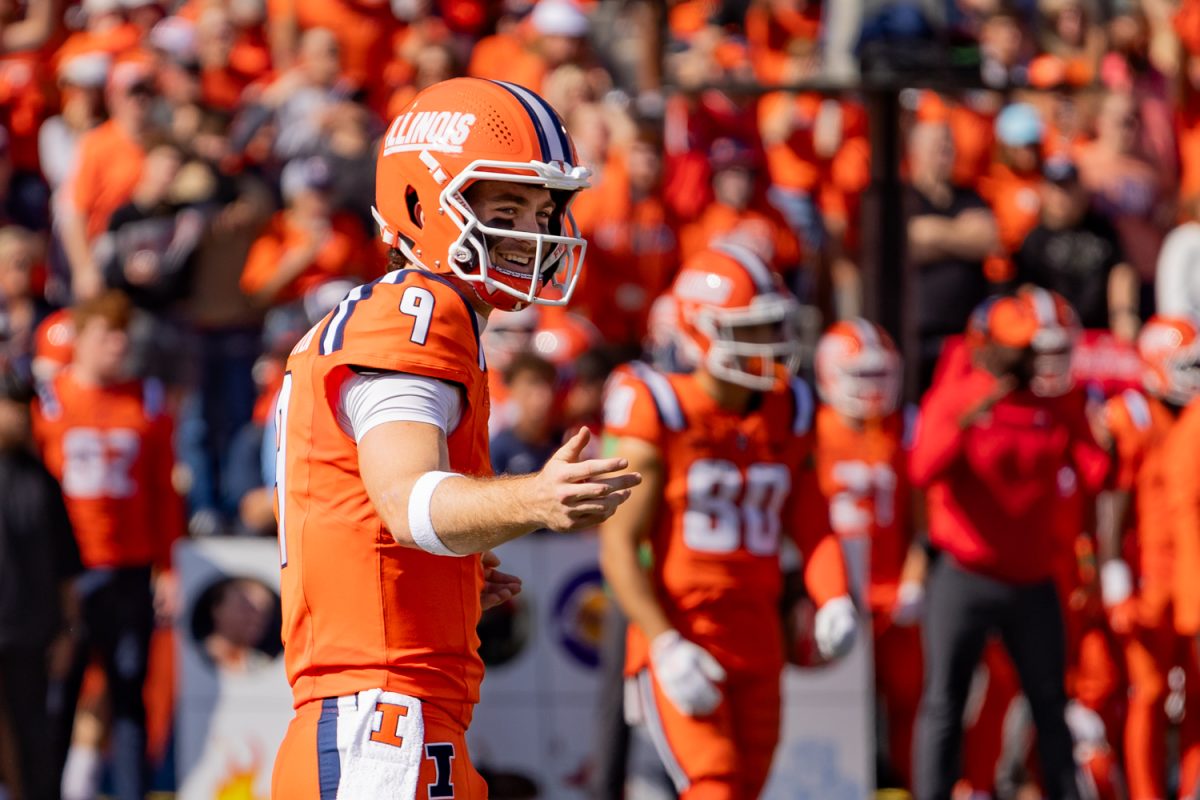 Senior quarterback Luke Altmyer smiles while talking to a teammate between plays during Illinois' game against Ohio State on Oct. 11.
