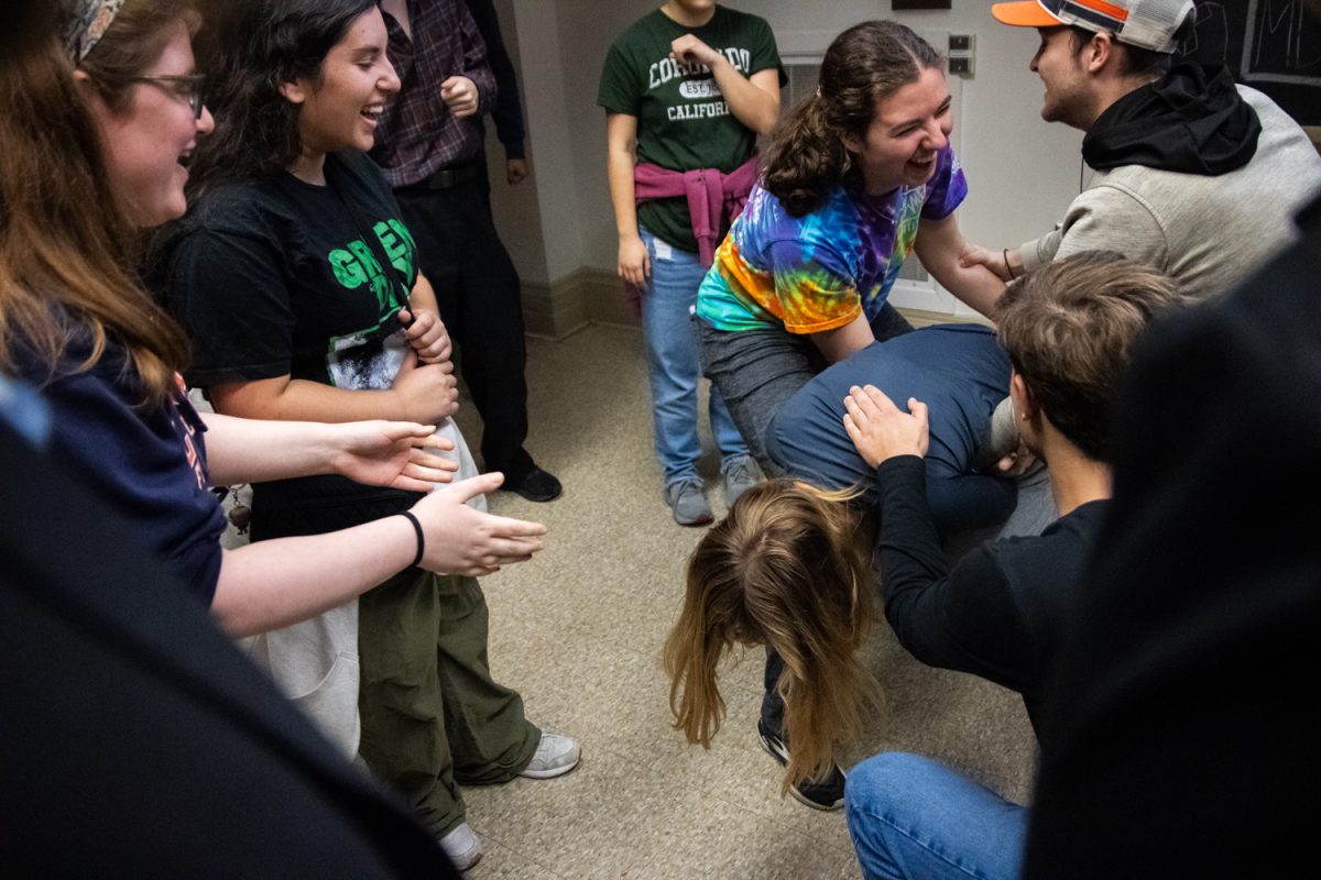 Students attempt to help their team member perform a front flip during a game at an Adenture Club meeting on Nov. 20.